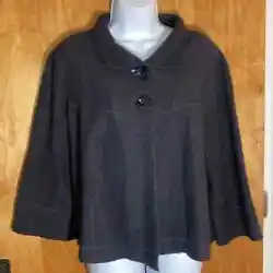 This is an adorable wool jacket with huge buttons. It has a loose poncho cape like fit. It also has wide sleeves as...