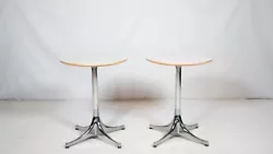 Pair of Herman Miller pedestal side tables designed by George Nelson, circa 2009. White laminate top with polished...