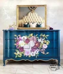 The front features a white and purple bouquet which is stunning against the deep blue. There are 6 drawers for storage....