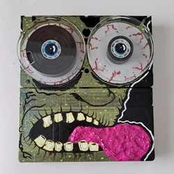 Original VHS Tape Head #6 in series sold by Artist lowbrow outsider art by Adam John Mulcahy. Acrylic paint on VHS tapes