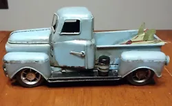 Vintage Collectible Handcrafted Pickup Truck Tin Metal Model with two surfboards in the back. Has rolling wheels....