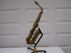 The Martin Alto saxophone, serial number 184965. There are a half dozen dents or more on the saxophone, ranging up to...