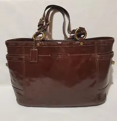 Nice, pre-owned Coach 11500 Brown Patent Leather Bag. Slip Pocket on each side that secure with toggle clasp. Interior...