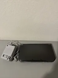 Nintendo NEW 3DS XL Gray Black Metallic Console W/Charger No Stylus (USA). There’s some paint chipping on the side of...