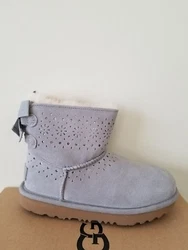Keep shining through winter with the charming UGG® Kids Dae Sunshine Perf boot. REAL UGG, 100% GENUINE, 100%...