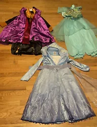 Outfits are in good condition. The Elsa dress has a brown stain in one place on the interior (see photo).