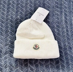 Stay cozy and stylish with this Moncler Cashmere Blend Beanie in a classic white color. Perfect for travel or casual...