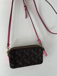 Coach Crossbody brown wallet purse with hot pink accentuations. Two zippered pockets and open middle pocket for phone....