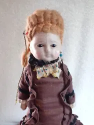 This is a rare mid-1800s antique wax over paper mache doll. It is sewn onto the body and very thin and fragile in the...