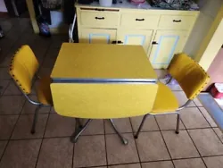 Vintage YELLOW Drop Leaf Formica Dining Table & 2 Chairs.  Minor wear due to age, but in overall good shape. Additional...
