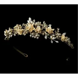 This exquisite floral tiara features stunning gold plating, clusters of creamy freshwater pearls, handcrafted porcelain...