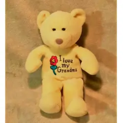 Cute bear is a bright lemon yellow, soft plush, bean bag bottom & embroidered 