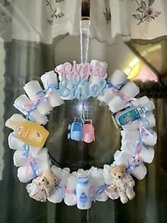 This delightful diaper wreath is perfect for welcoming a new bundle of joy! Featuring Pampers brand diapers, this...