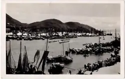 We offer this real photo postcard of Dragon Boats racing in the harbor near Hong Kong, China. Fine panoramic view taken...