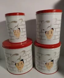 The set includes four canisters of different sizes, each with a lift-off lid featuring a charming chef character....