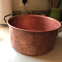Could be a lovely decorative pot, maybe in a fireplace. Its not tin coated or coated at all; I believe it is solid...