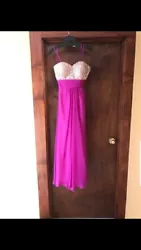 Size 4 magenta prom dress worn once in great condition. Strapless with criss cross in back, bling.