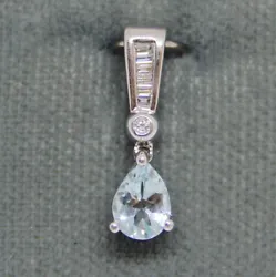 Pear shape aquamarine. 0.06 CTW diamond accents. 5.7 mm wide. 19 mm long.