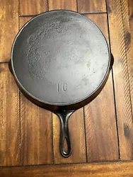 Unmarked No. 10 cast iron skillet with outside heat ring. Skillet sits flat with no wobble or spin. Stripped in...