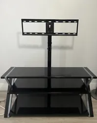 Adjustable Black Tv stand with three selves. It fits 32 inch - 65 inch. ONLY PICK UP MIAMI FL