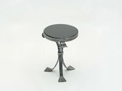 Hand produced in France in the early 1940s, this tripode gueridon features silky wrought steel legs with a beautiful...