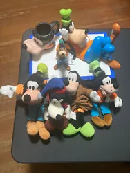 Mixed lot of different times Disney goofy items 4 plush 1 ceramic figure has some scrapes goofy cup and goofy bank not...