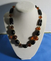 It has faux amber beads, jet black beads and gold tone spacers.