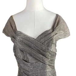 Champagne gold. Short cap sleeves. Wrap look bodice. Length: 43