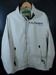Tommy Hilfiger Sailing Gear Jacket. Windbreaker style. Zip front with snap wind flap. The color is just off white. In...