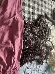 Two pairs of XL scrubs very good condition. The pink scrub paints are the joggers type.