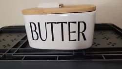 Super cute butter dish with lid and spreader. Brand new. Its white with black writing. Will go with just about any...
