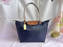 NEW Longchamp Le Pliage tote bag. Nylon; trims: leather. Top zip closure. Interior slip pocket. opening : 46CM...