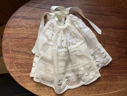 This is a cream colored fabric and lace petticoat that has a drawstring waist with a ribbon tie. The doll could have...