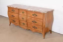 By John Widdicomb. A gorgeous French Provincial Louis XV style bombe form nine-drawer triple dresser or credenza....
