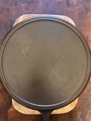 A really nice Erie Cast Iron Skillet No. 11, P/N 717 with inset Heat Ring. I wish I could say it sits dead flat but...