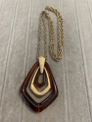 Vintage Avon Signed gold tone necklace with large Amber Lucite pendant. This is a pre-owned item from an estate sale...
