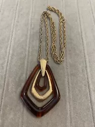 Vintage Avon Signed gold tone necklace with large Amber Lucite pendant. This is a pre-owned item from an estate sale...