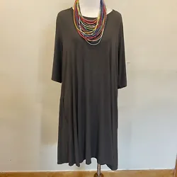 Eileen Fisher gray jersey swing dress with inseam pockets and short sleeves. Gently worn and in good preowned...