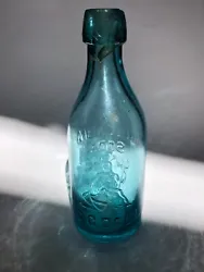 Classic semi-scarce western blob top bottle. Nice deep aqua with strong embossing and a perfect seated liberty.