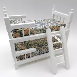THE BEDDING AND PILLOWS ARE A BEAUTIFUL FLORAL PATTERN.