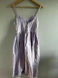 This is a women’s spaghetti strap tank top dress, size small. It is lavender with white stripes. It has 5 functional...