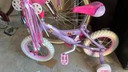 Huffy Disney princess girls bike 12” with doll seat in basket and training wheels. Excellent condition.