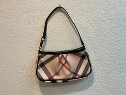You are looking at luxury. Made from beige Nova check coasted canvas. It features a pleated front and piping, and a...