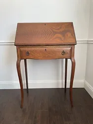 Antique desk with drop front.There are 5 slots inside for miscellaneous items and a small drawer that is 11” x 6”We...