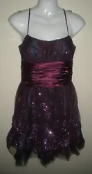 This is for Morgan & Co Dress. The dress is dark purple and black. It is lined in black. It has netting overlay. It has...