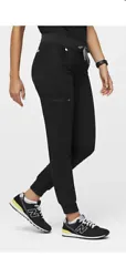 Introducing the stylish Figs Womens Black Zamora Jogger Scrub Pants in size Medium Regular. These pants are perfect for...
