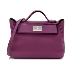 This is an authentic HERMES Togo Swift 24/24 29cm Anemone. This handbag is crafted of richly textured calfskin leather...