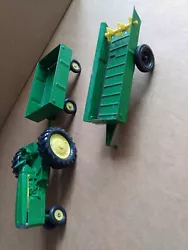 Used Ertl John Deere tractor and 2 trailers. All 3 show signs of wear. Paint is chipped. View all photos.