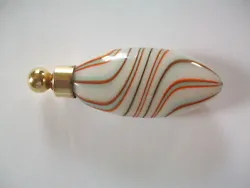 Gold glass dauber fits snugly. white with orange, blue, brown & sparkly gold swirls.