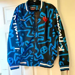 This Keith Haring Tokyo Pop Script Windbreaker is a must-have for any fashion-forward man. Featuring a comfortable...